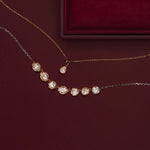 Lisse Diamond Cushion Charm and Lisse Seven Stone Diamond Necklace draped in front of a burgundy jewelry box
