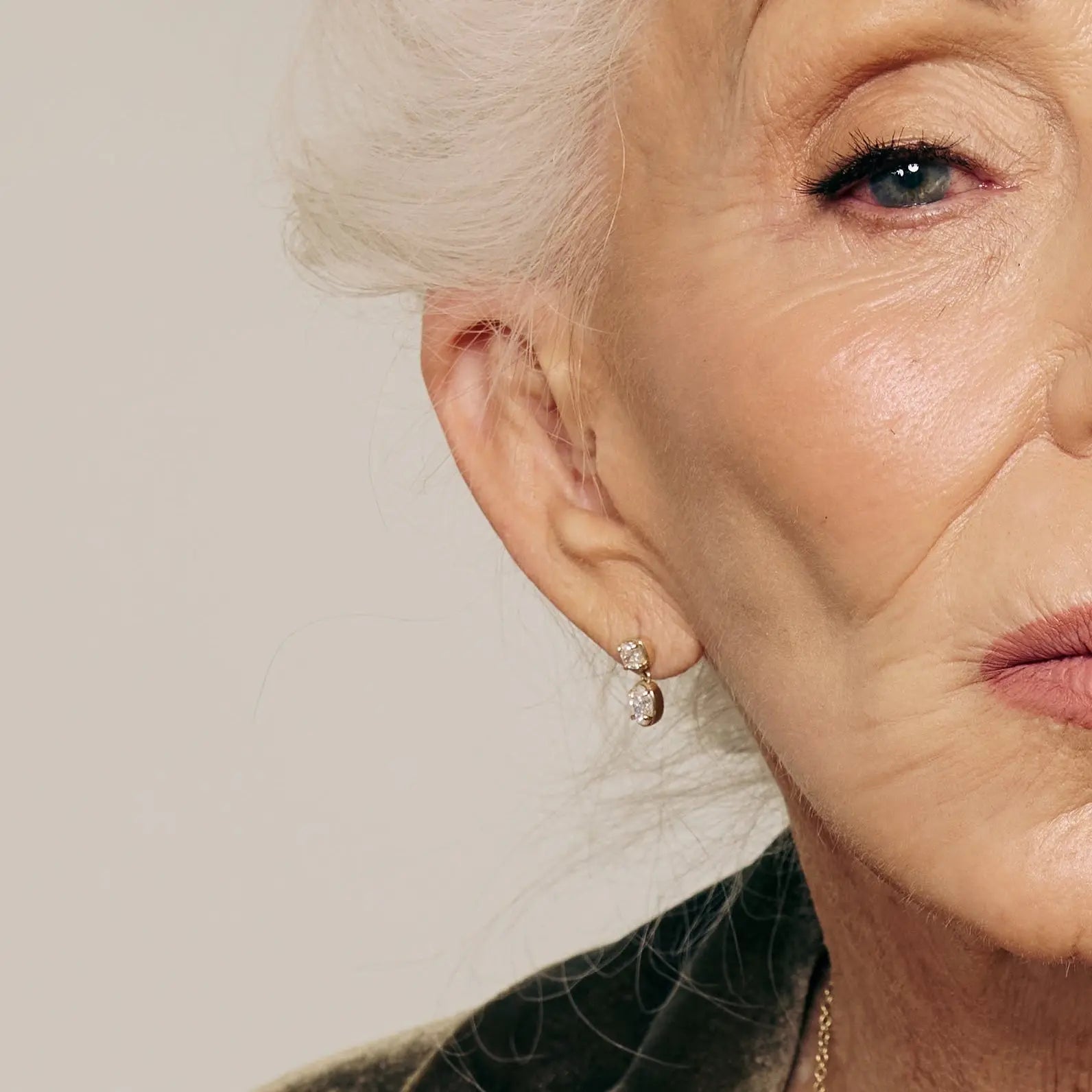 Close-up of an elderly woman's face with a neutral background