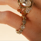 close up of woman's hands wearing multiple yellow gold and diamond rings