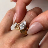 marquise diamond ring and gold twist ring on hand