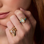 Close up of woman with hands near her face, wearing the Mary Opal Abstract Bezel Ring