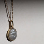 Moonstone Scarab Necklace against neutral background