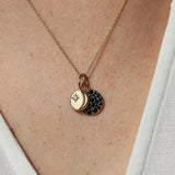 Necklace with two pendants on a person's neck