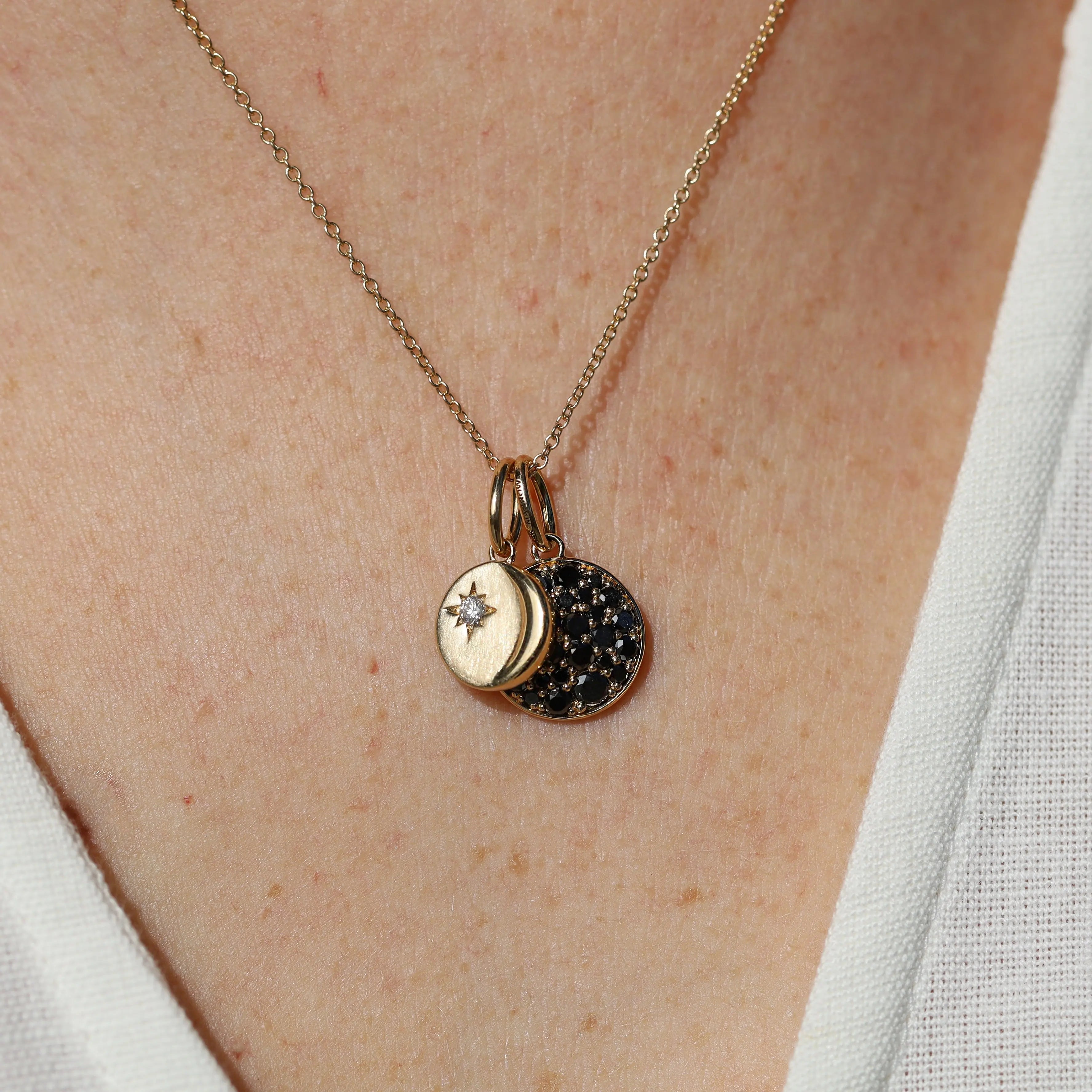 Necklace with two pendants on a person's neck