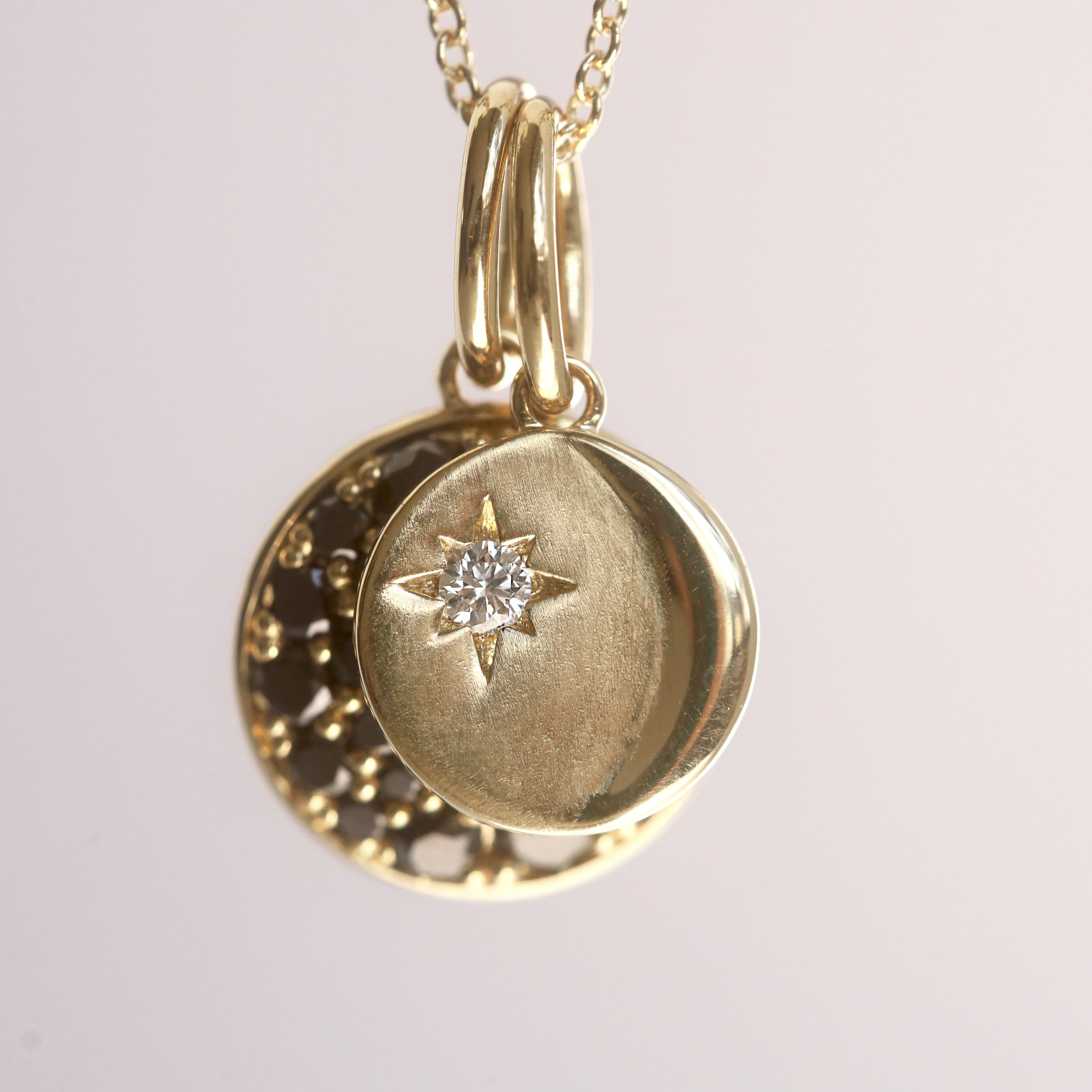 Gold pendant necklace with star design on a light gray background