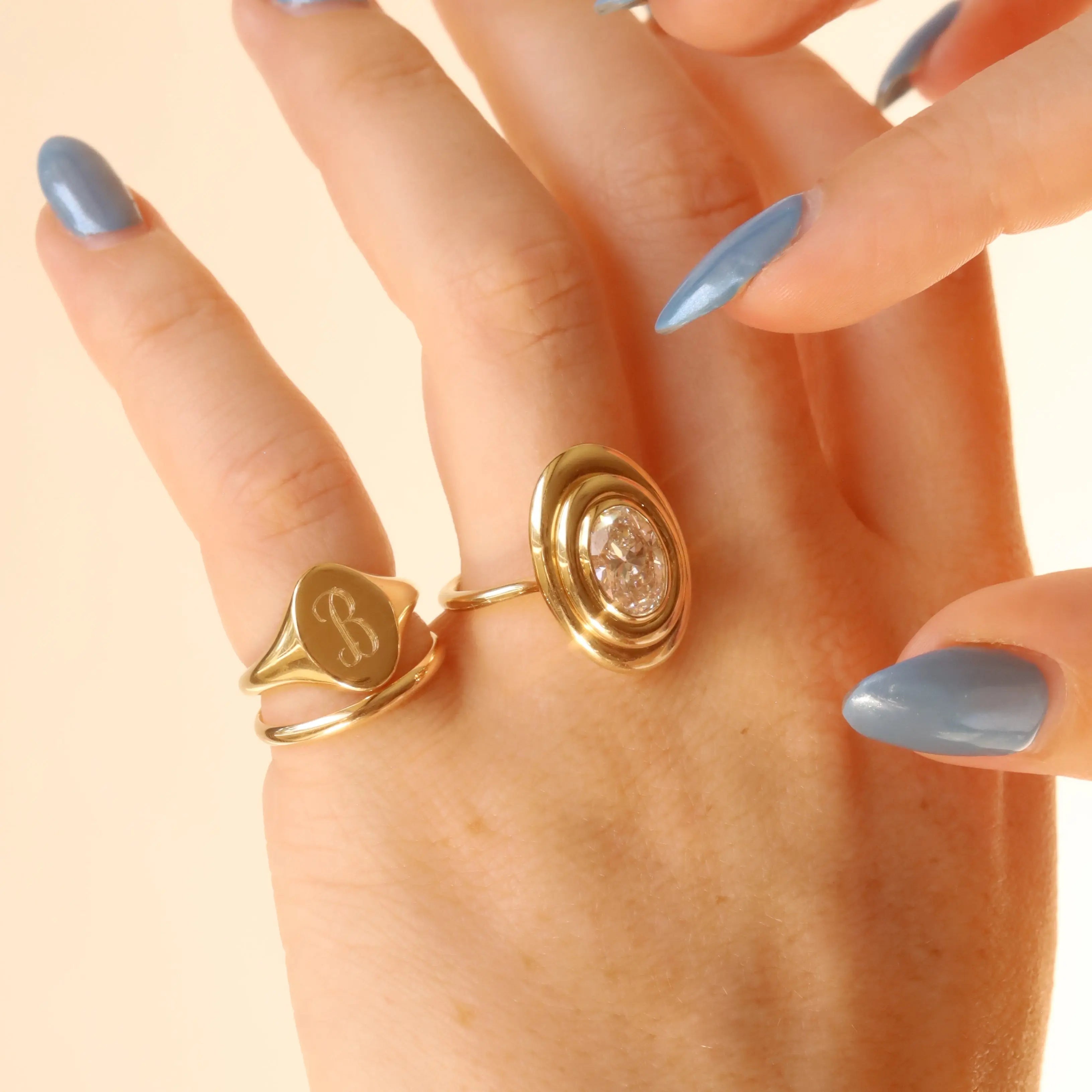 Gold rings on a hand with light background