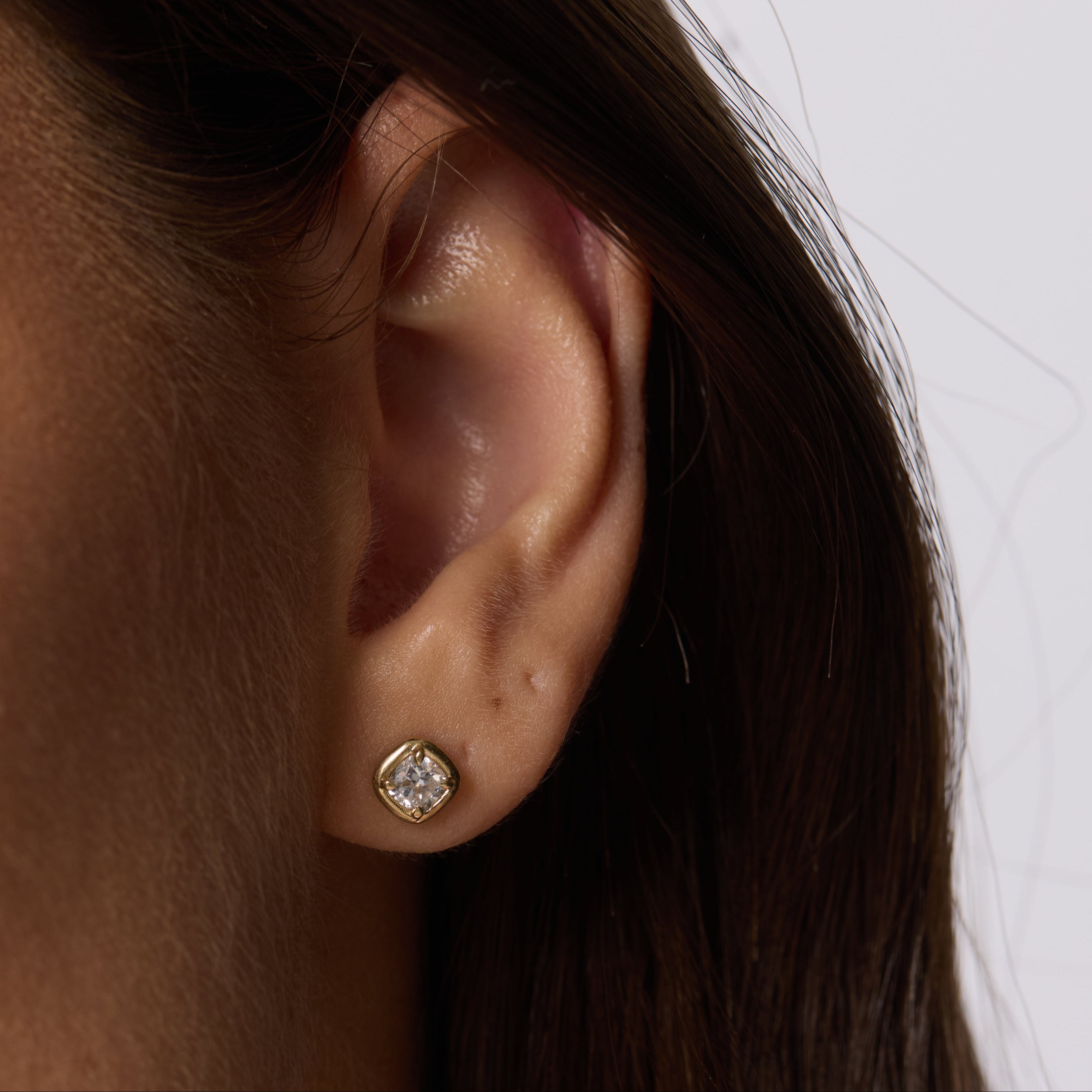 Close up of woman ear spotlighting Nina Cushion Studs