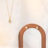 Flat lay of Nina Cushion Studs and Nina Cushion Pendant