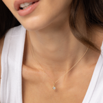 Close up of Nina Cushion Pendant on woman's décolletage 
