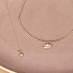 Flat lay of Nina Cushion Pendant and Odette Oval Collar
