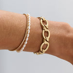 Everyday Pearl Bracelet on wrist styled with other Marrow Fine bracelets