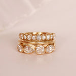 flat lay of diamond and gold bands on a pinkish background