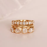 flat lay of diamond and gold bands on a pinkish background