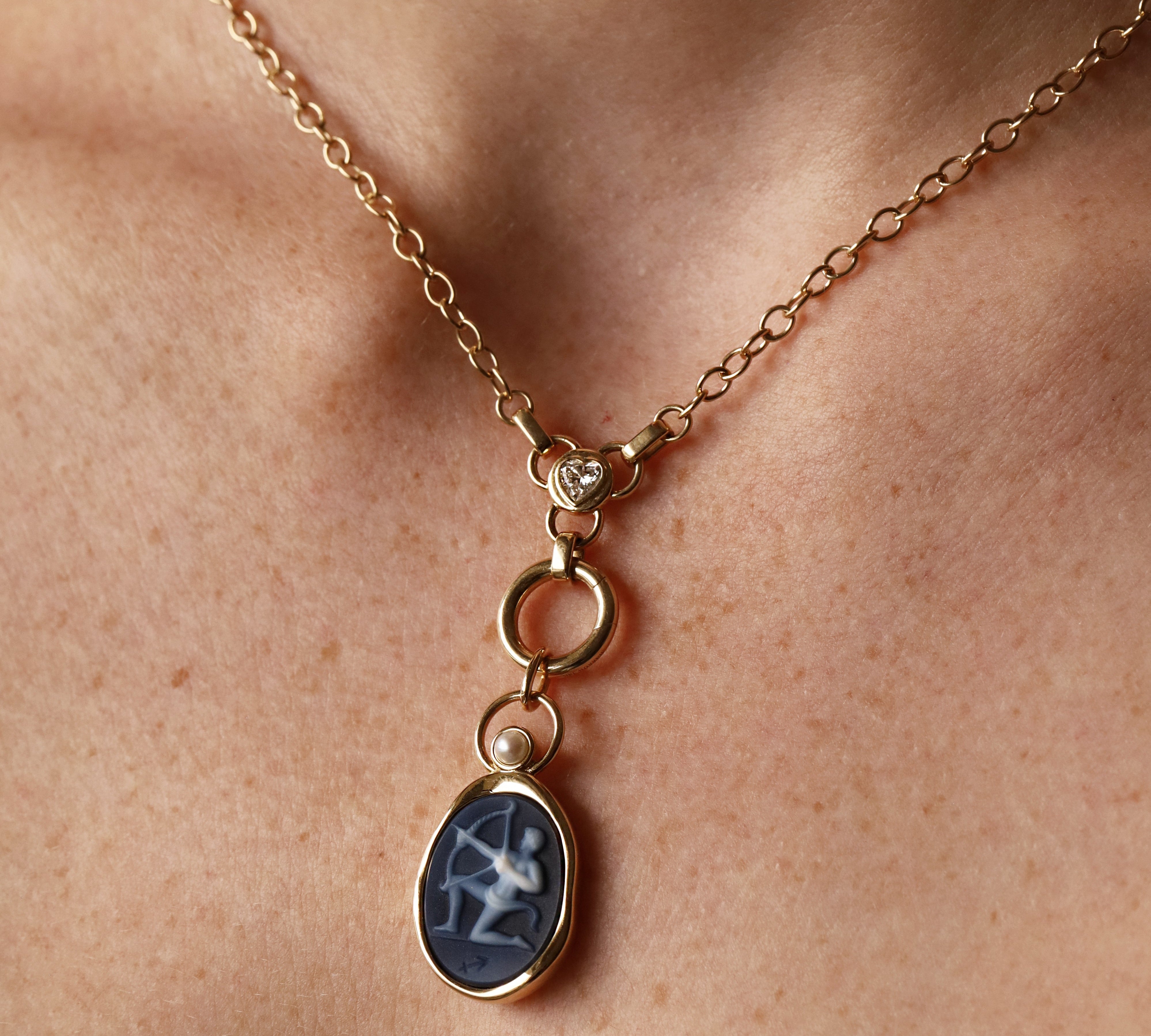 Sagittarius Zodiac Black Agate Carving with Pearl pendant – white archer carved on black agate in 14k yellow gold, with a white cultured pearl above the carving