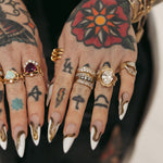 Close up of Sammi Jefcoate's hands, featuring the Marrow x Sammi Florence Engagement Ring, stacked with the Arno Serpent Band