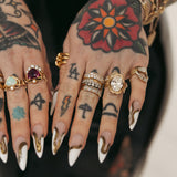 Close up of Sammi Jefcoate's hands, featuring the Marrow x Sammi Florence Engagement Ring, stacked with the Arno Serpent Band