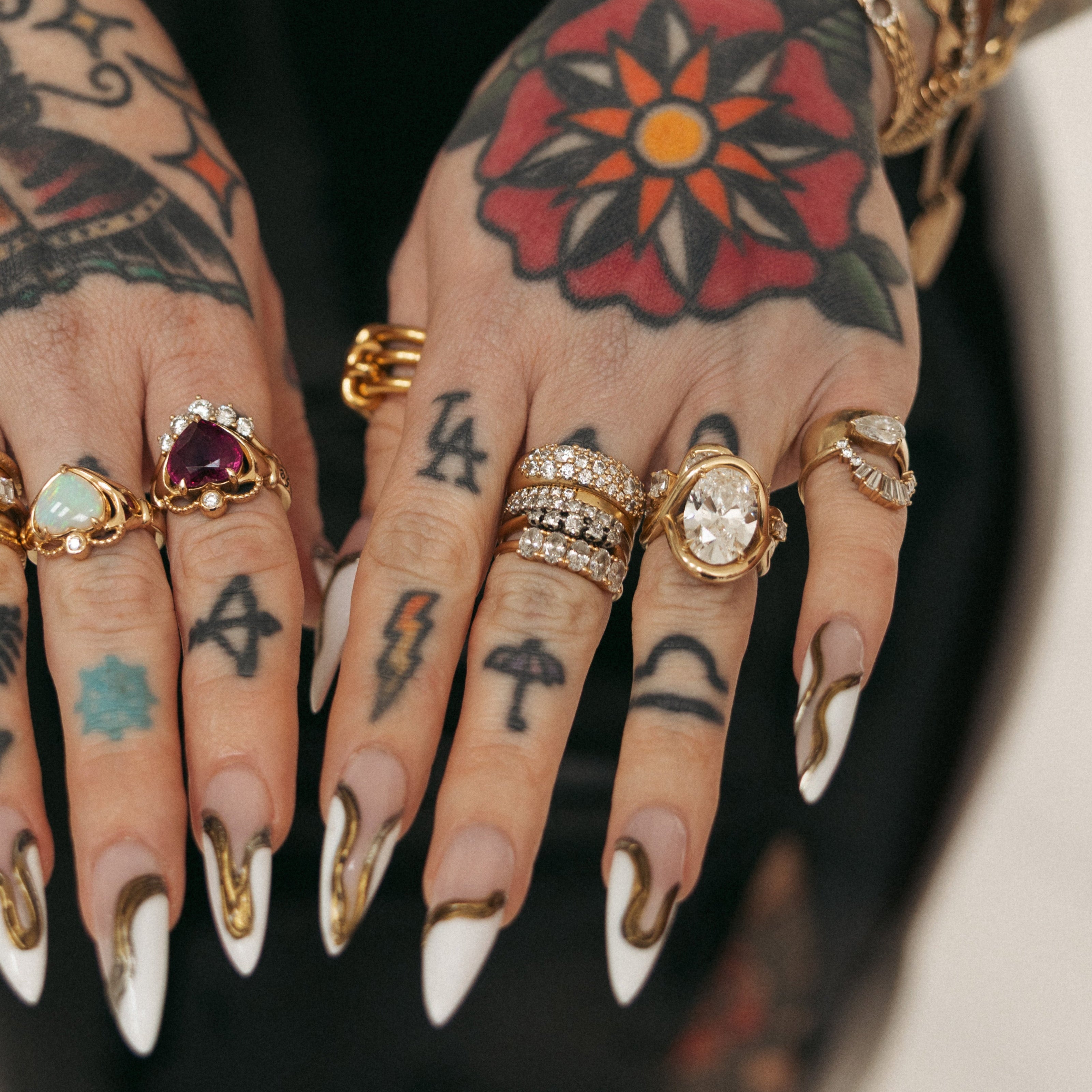 Close up of Sammi Jefcoate's hands, featuring the Marrow x Sammi Florence Engagement Ring, stacked with the Arno Serpent Band