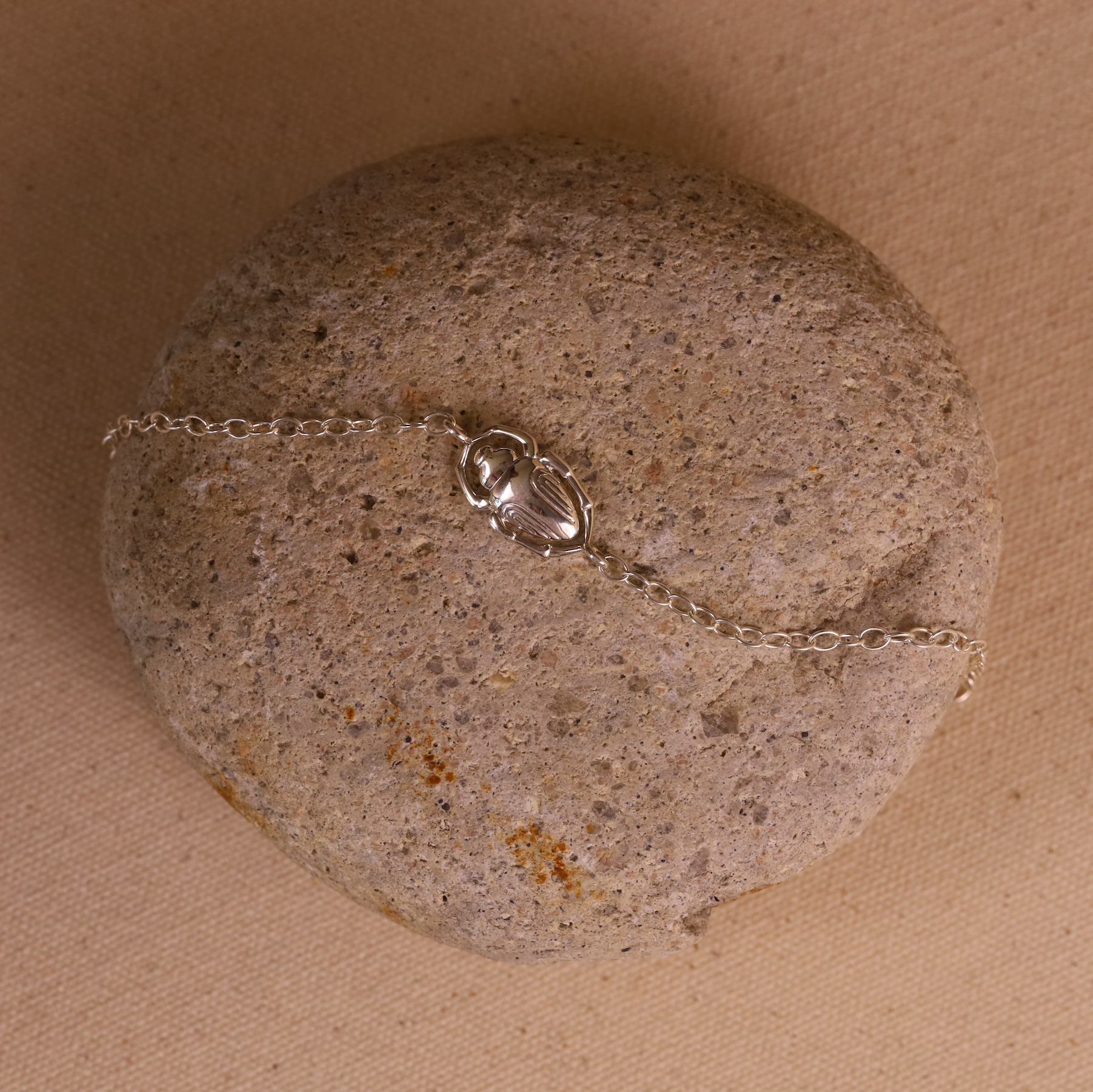 Silver bracelet on a textured stone surface
