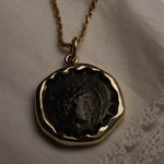Seleucid Kingdom coin pendant worn on a chain, showing the profile of Antiochos VI Dionysos
