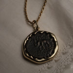 Seleucid Kingdom coin pendant worn on a chain, showing the elephant side