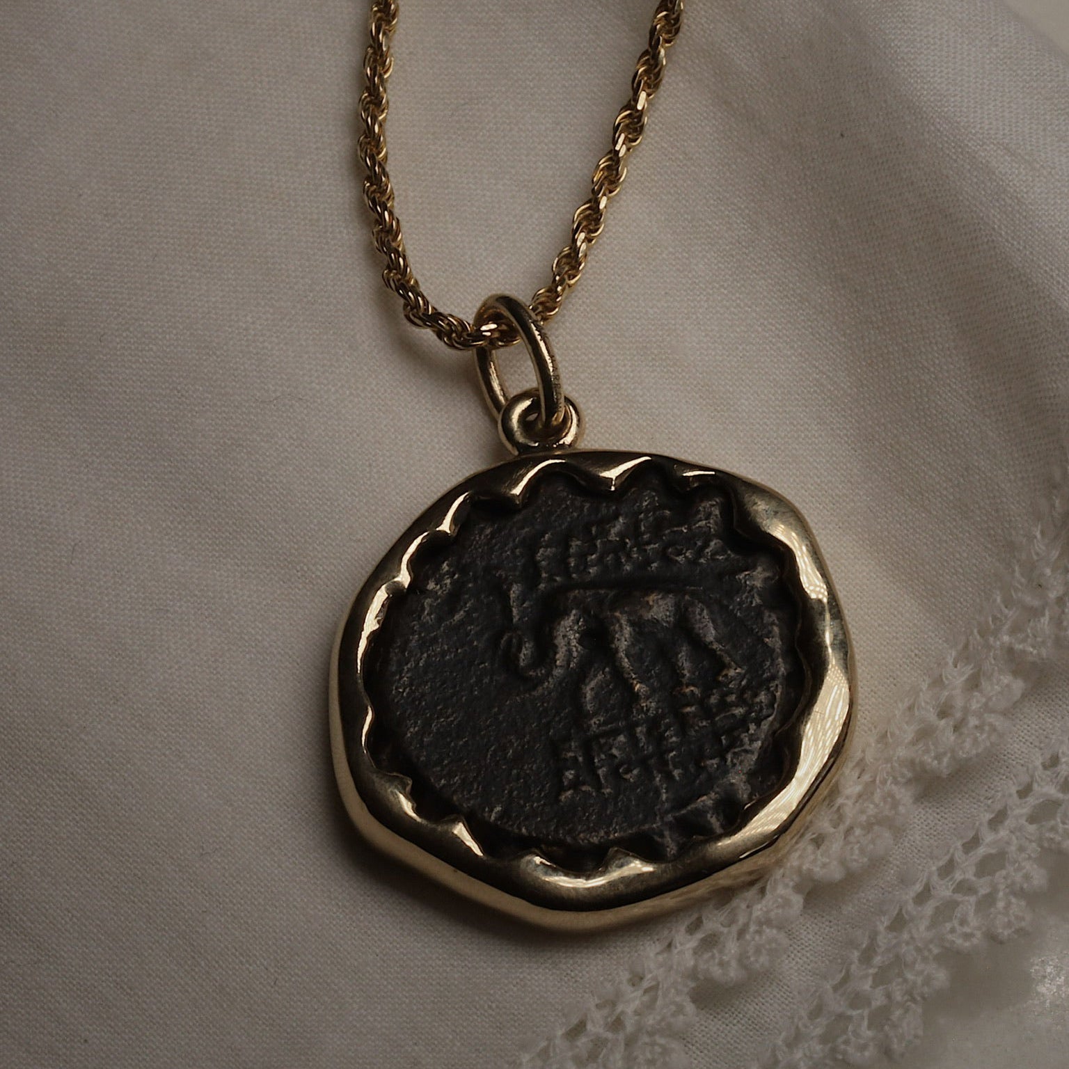 Seleucid Kingdom coin pendant worn on a chain, showing the elephant side