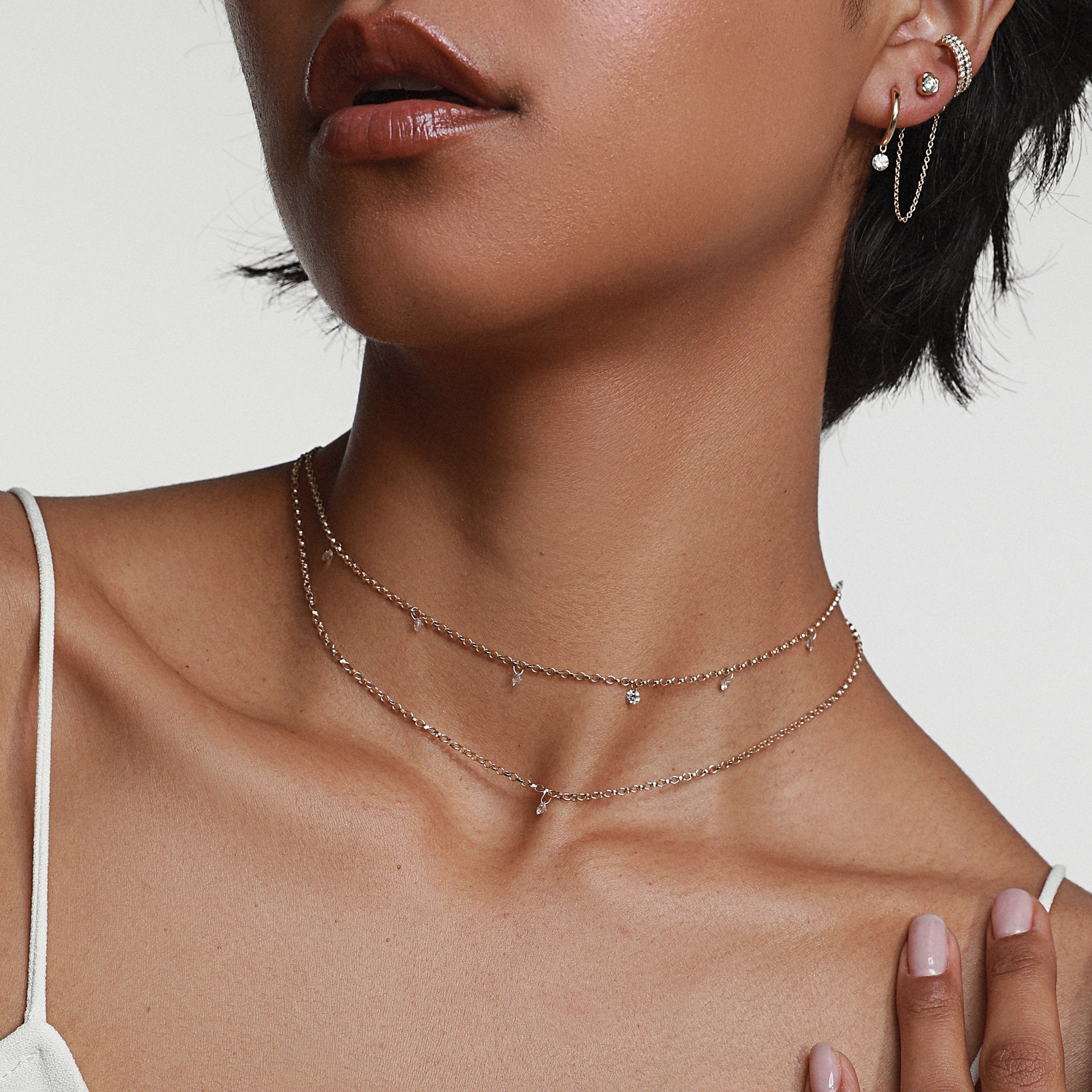 close up of woman's décolletage featuring the Seven Stone Diamond Drop Choker