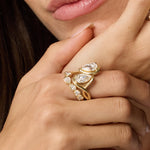 Close up of Joanie Bypass Ring and Simone Arch Band stacked on woman's finger