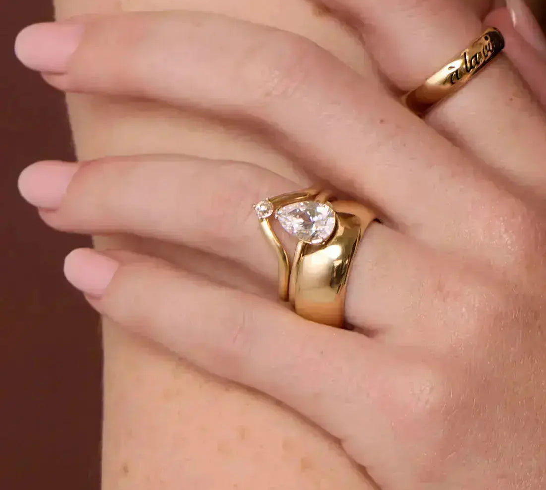 The Sloane Pear Solitaire Engagement Ring, close up on hand