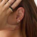 close up of woman's hear wearing Marrow Fine diamond studs and rings
