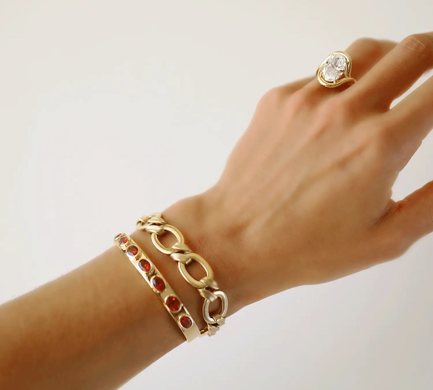 Image of Sunstone Cuff stacked with the Twist Link Bracelet on a wrist.
