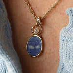 Close-up of the Swan Carving with 3.8mm Pearl Charm on the neck – white swans carved on violet agate, set in 14k yellow gold on a gold chain