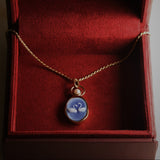 Swan agate carving pendant in 14k yellow gold with a 3.8mm pearl in an open gold ring