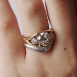 Gold and silver ring with diamonds on a finger