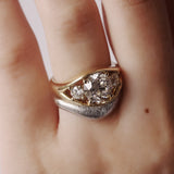 Gold and silver ring with diamonds on a finger