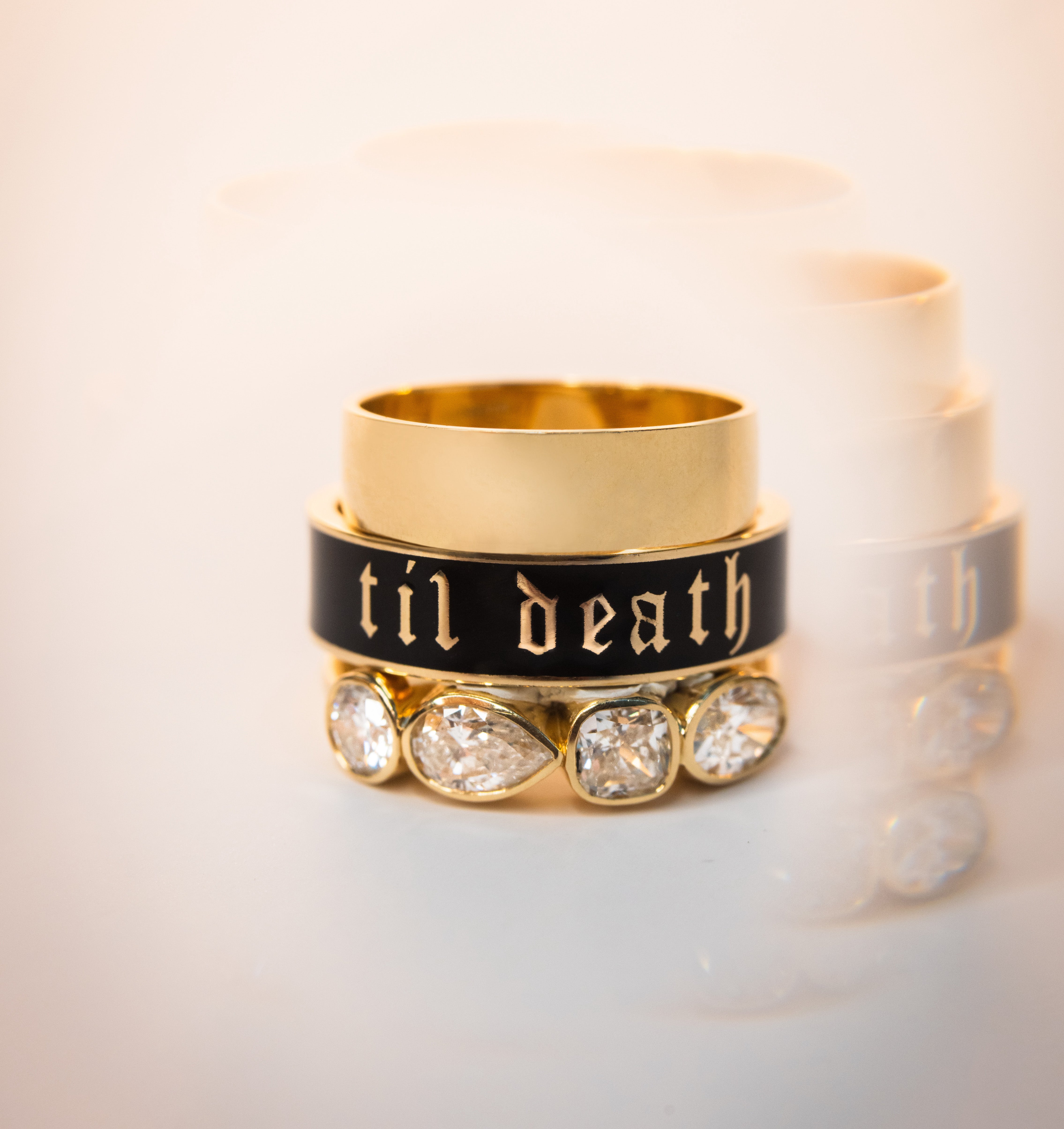 Flat lay of Marrow Fine Til Death Band, with Everyday Band stacked on top and the White Diamond Mixed Shape Bezel Band stacked below