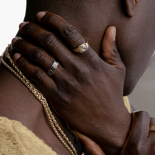 man hands caressing neck, with Marrow jewelry (rings and necklaces)