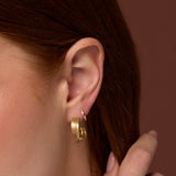 Close up of woman's ear wearing Everyday Twist Hoops