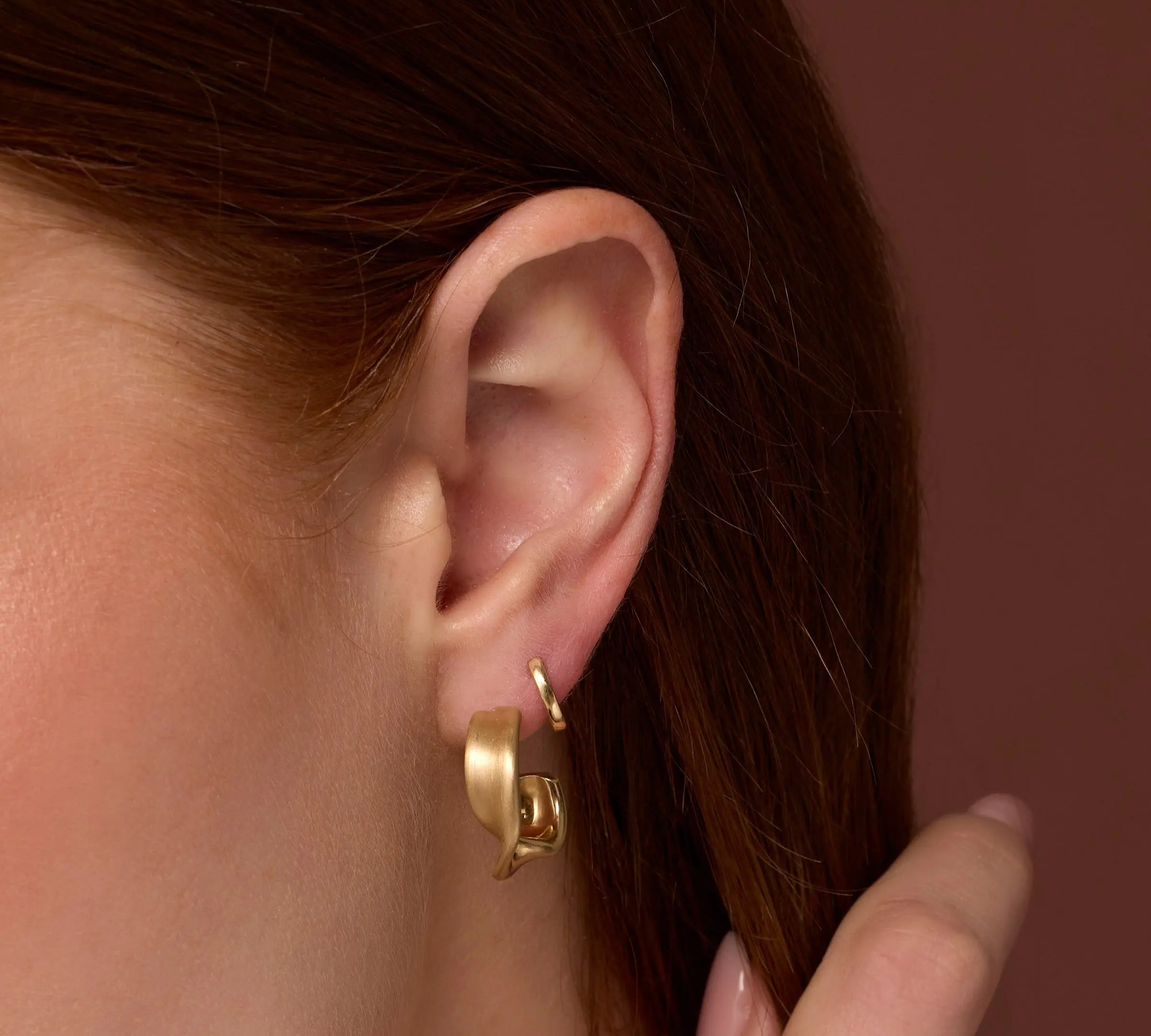 Close up of woman's ear wearing Everyday Twist Hoops