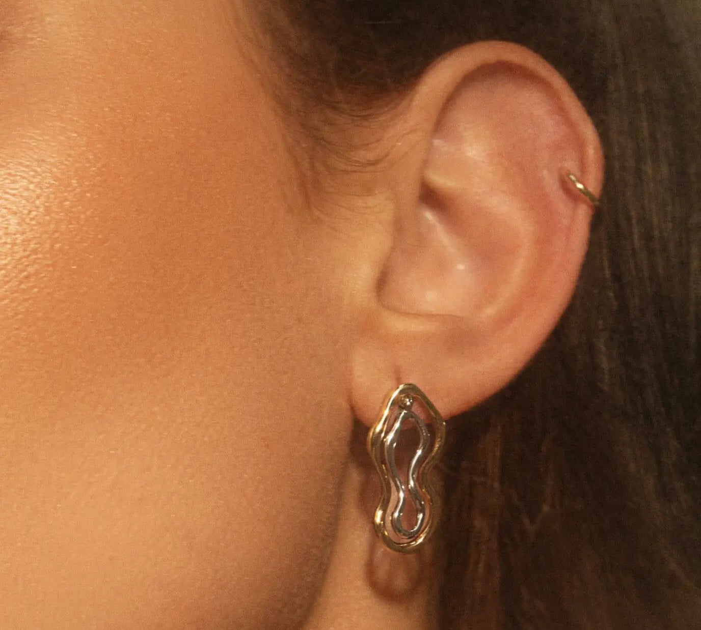 Two Tone Sculptural Freeform Earrings on woman's ear