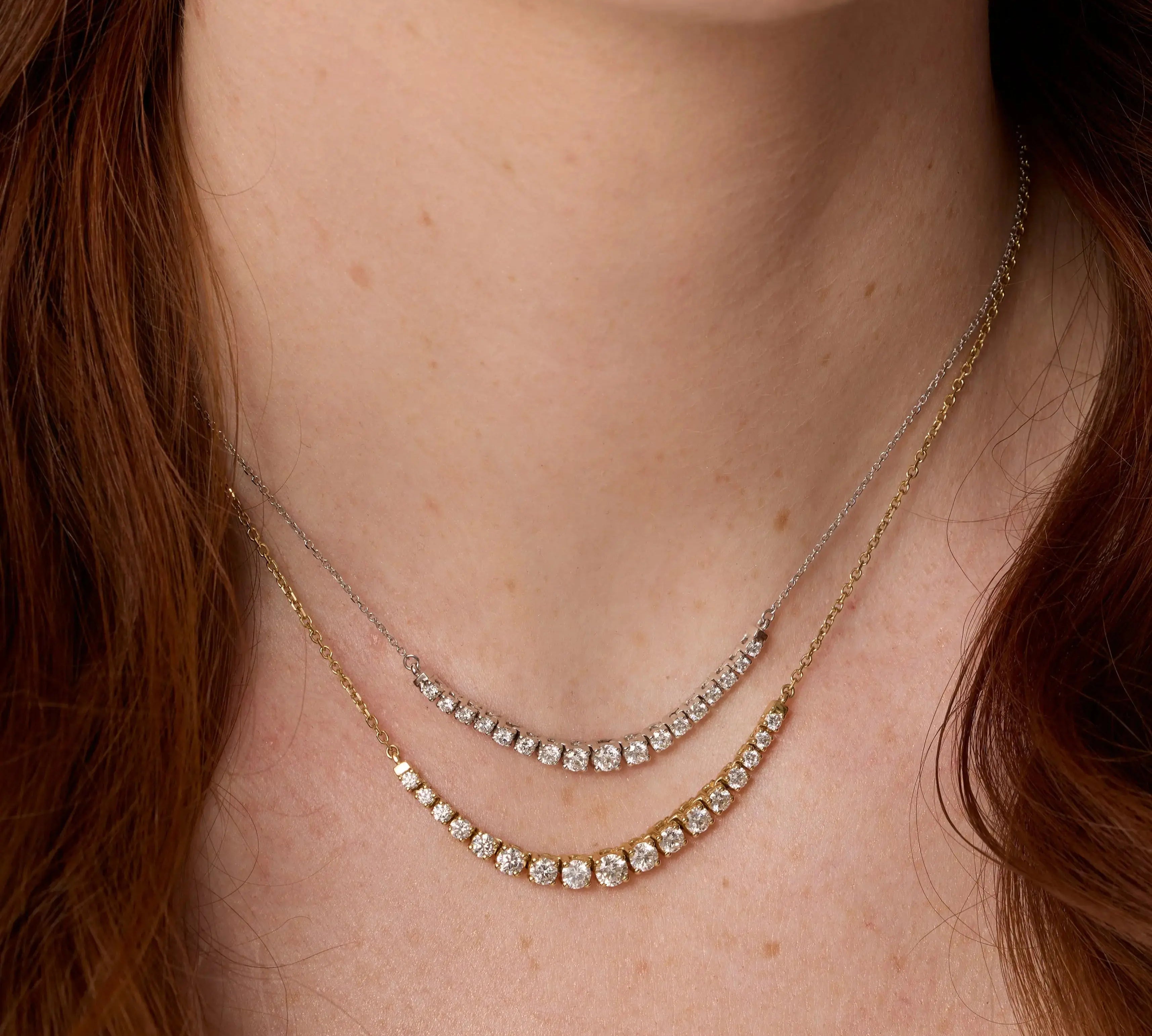 Close up of woman's décolletage spotlighting the Venus White Diamond Graduated Necklace and The Naomi White Diamond Graduated Necklace