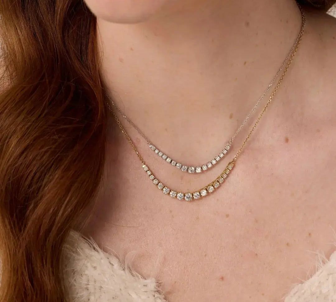 Close up of woman's décolletage spotlighting the Venus White Diamond Graduated Necklace and The Naomi White Diamond Graduated Necklace