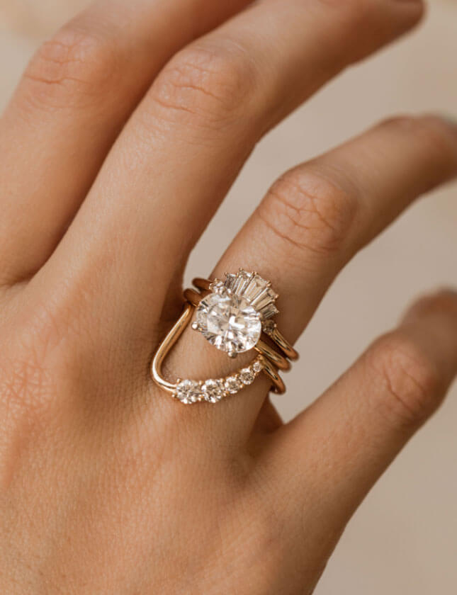 engagement ring on hand with stacked rings