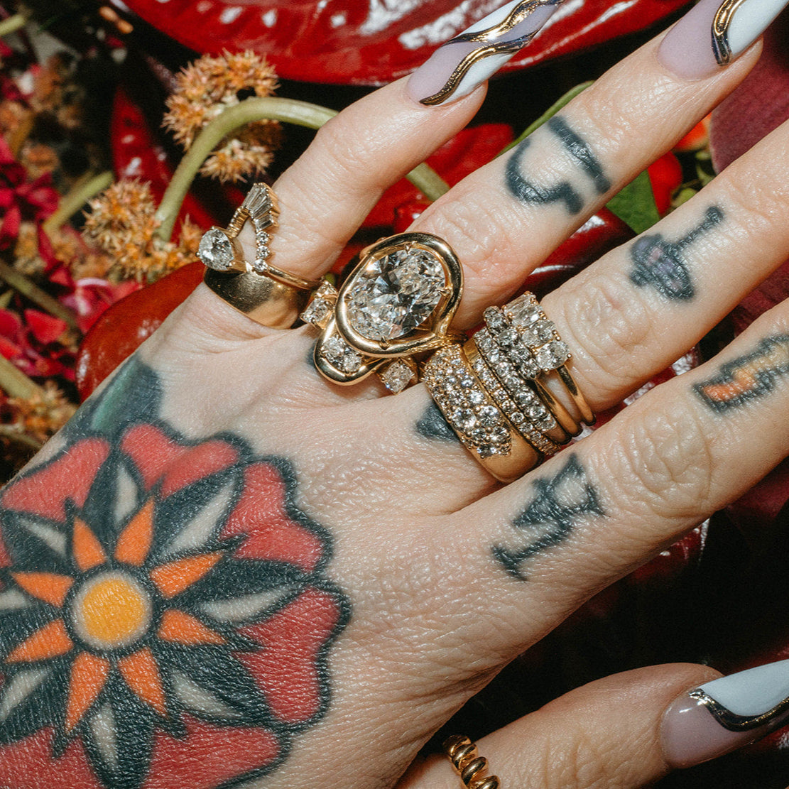 Close up of Sammi Jefcoate's hands, featuring the Marrow x Sammi Florence Engagement Ring, stacked with the Arno Serpent Band