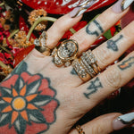 Close up of Sammi Jefcoate's hands, featuring the Marrow x Sammi Florence Engagement Ring, stacked with the Arno Serpent Band
