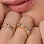 Close up of woman resting hands against chin with the Marrow Fine White Diamond Mixed Shape Bezel Band