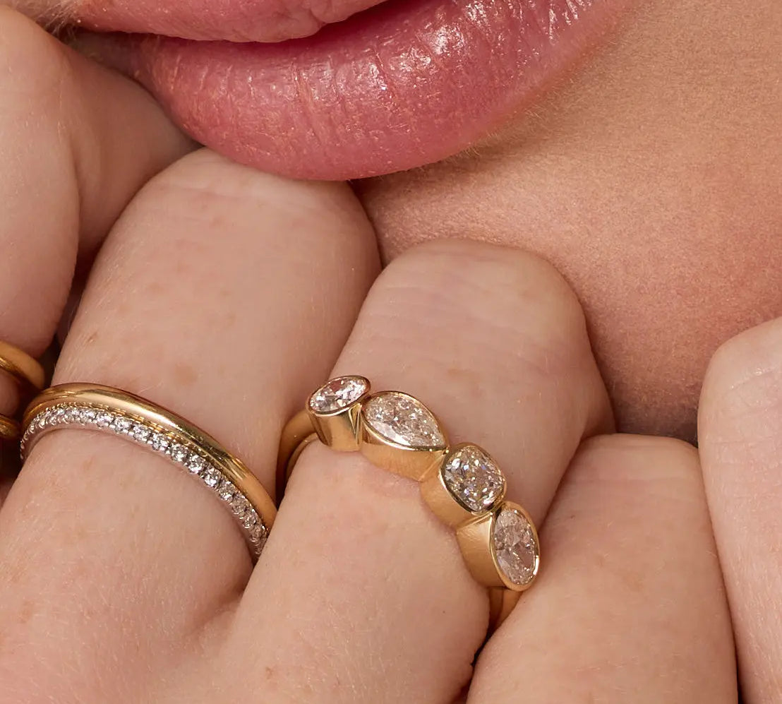 Close up of woman resting hands against chin with the Marrow Fine White Diamond Mixed Shape Bezel Band