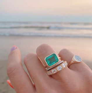 hand with Marrow Fine rings over beach