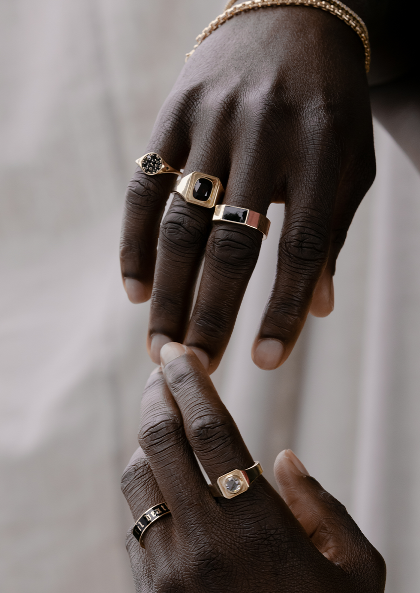 man hands touching with multiple Marrow rings