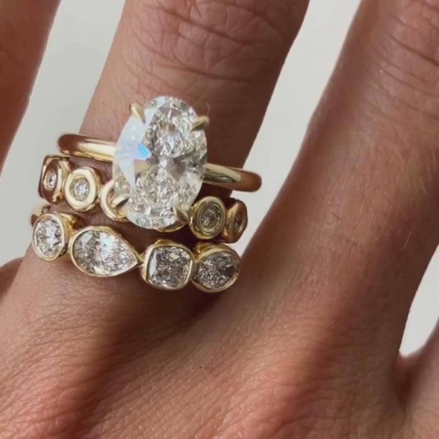 Vide of White Diamond Mixed Shape Bezel Band stacked on hand