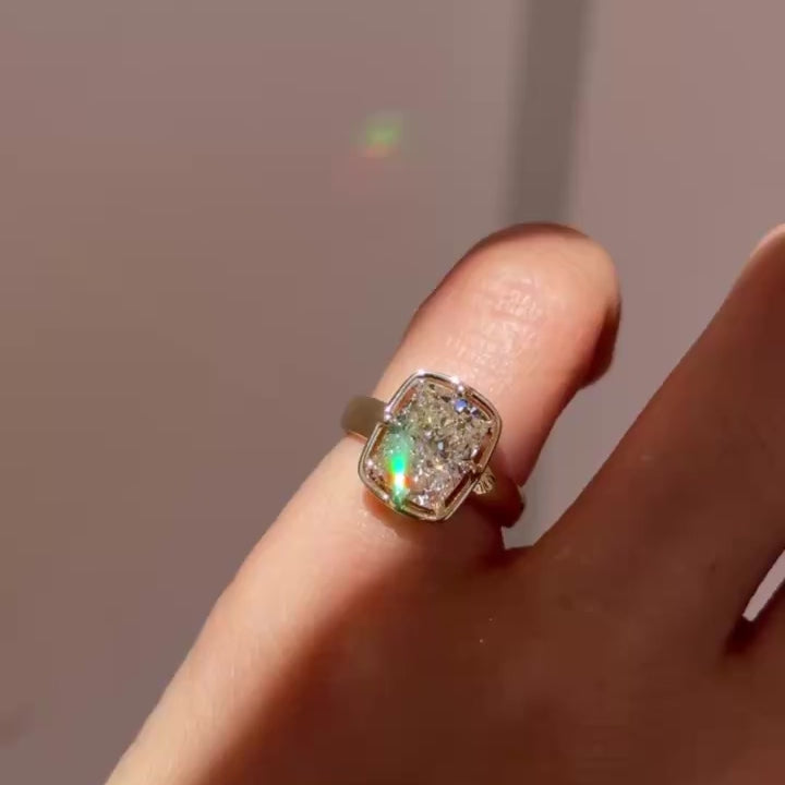 Video of yellow gold diamond engagement ring in a Georgian inspired setting worn on pinky glimmering in a stream of light.